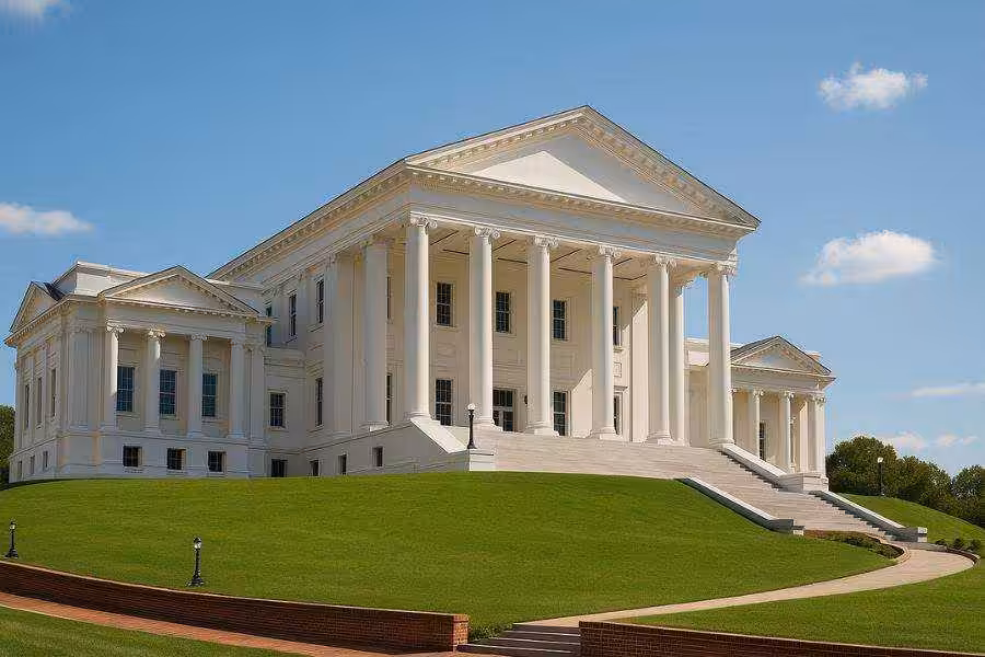 White capitol-style building with columns and blue sky.